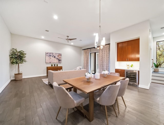 dining area with dark hardwood / wood-style floors, beverage cooler, and plenty of natural light