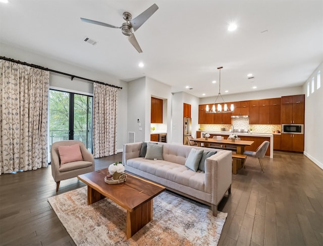 living room with ceiling fan and dark hardwood / wood-style flooring