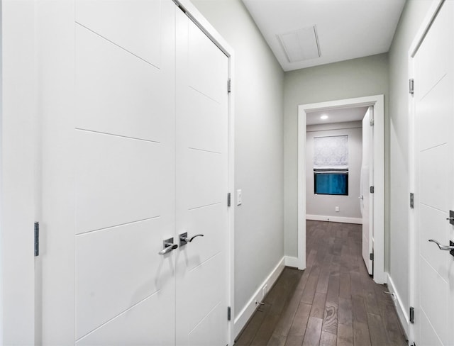 hallway with dark hardwood / wood-style floors