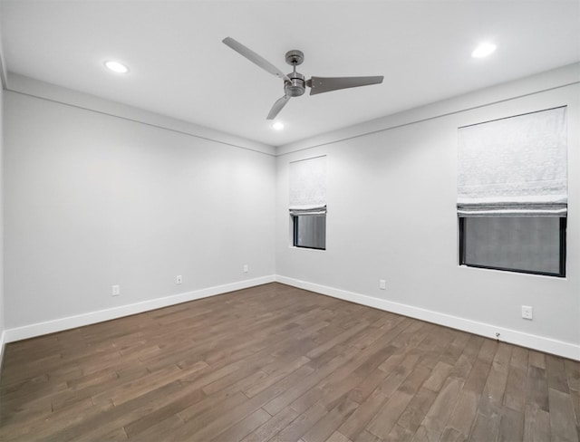 spare room with ceiling fan and dark hardwood / wood-style flooring