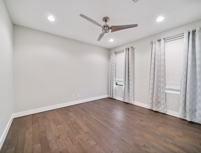 empty room featuring ceiling fan and dark hardwood / wood-style flooring