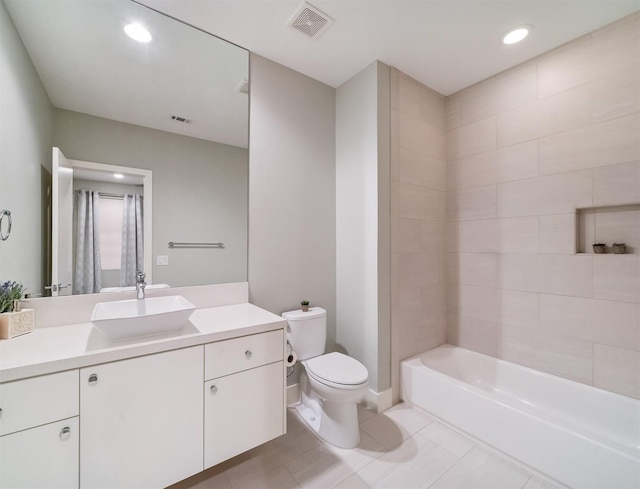 full bathroom with toilet, vanity, tile patterned flooring, and tiled shower / bath combo