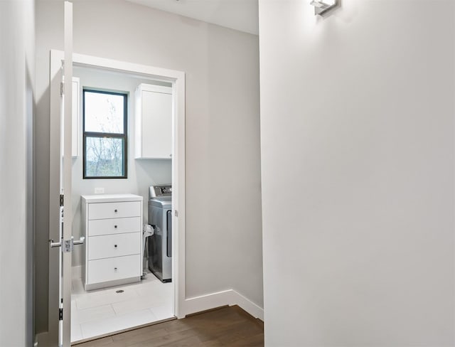 interior space featuring light wood-type flooring, cabinets, and washer / clothes dryer