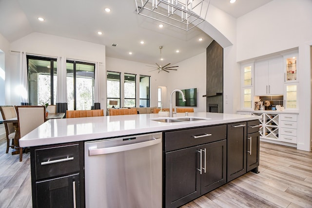 kitchen featuring white cabinetry, an island with sink, ceiling fan, stainless steel dishwasher, and sink