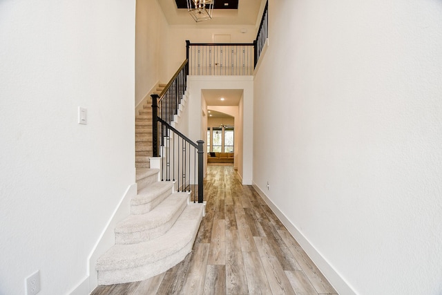 interior space with wood-type flooring and a towering ceiling