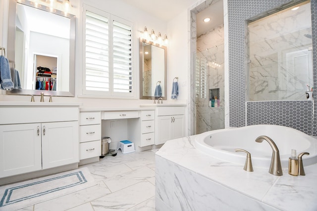 bathroom with vanity and separate shower and tub