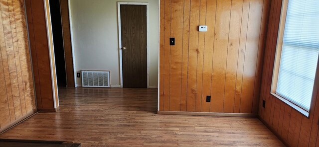 2180 Washington Ave, Alvin, TX 77511 - unfurnished room featuring wood walls, wood finished floors, and visible vents