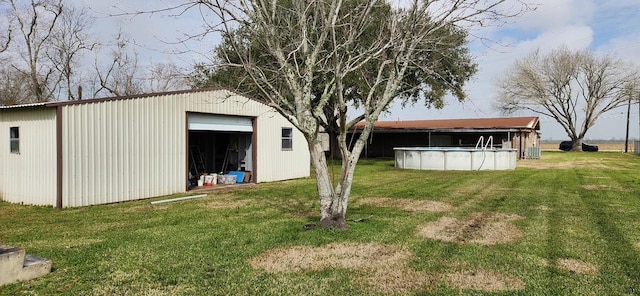 exterior space featuring an outbuilding, central AC, a detached garage, and an outdoor pool