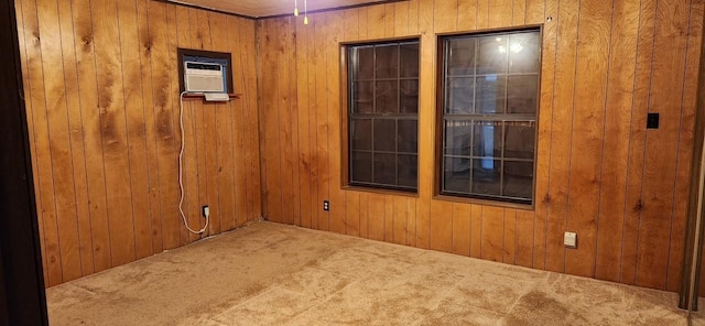 unfurnished room with carpet floors, wooden walls, and a wall mounted air conditioner