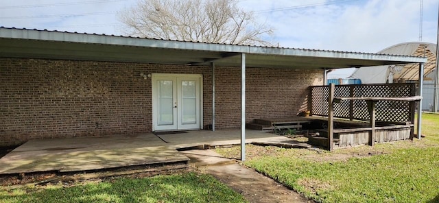 2180 Washington Ave, Alvin, TX 77511 - rear view of house with a wooden deck, a yard, and brick siding