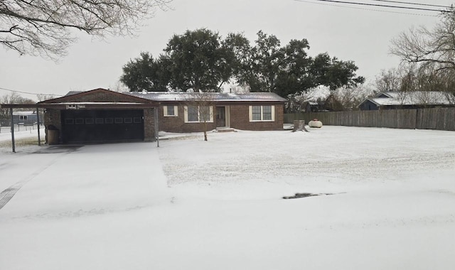 ranch-style home featuring an attached garage and fence