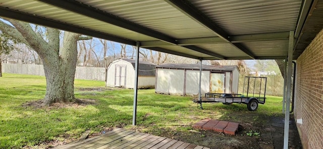 exterior space featuring a storage unit, an outdoor structure, and fence