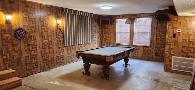 2180 Washington Ave, Alvin, TX 77511 - playroom featuring wooden walls, a textured ceiling, concrete flooring, and billiards