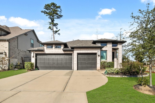 view of front of home featuring a garage and a front lawn