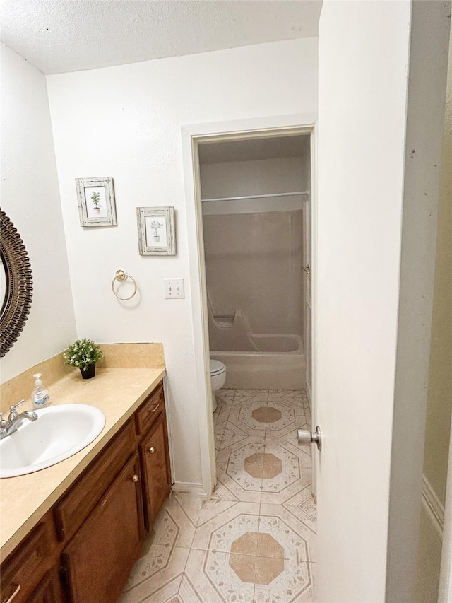 bathroom featuring a textured ceiling, tile patterned floors, vanity, and toilet