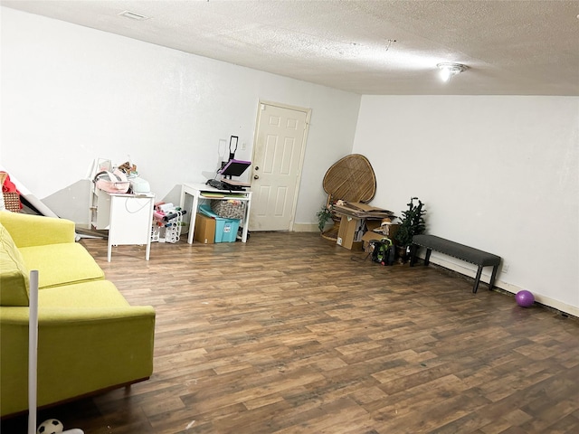 interior space with dark hardwood / wood-style flooring and a textured ceiling