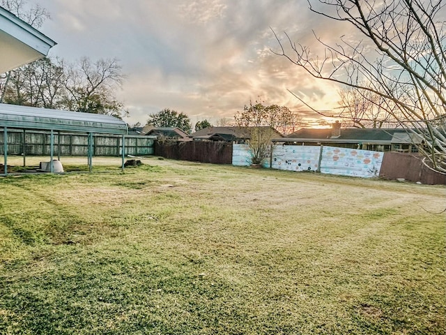 view of yard at dusk