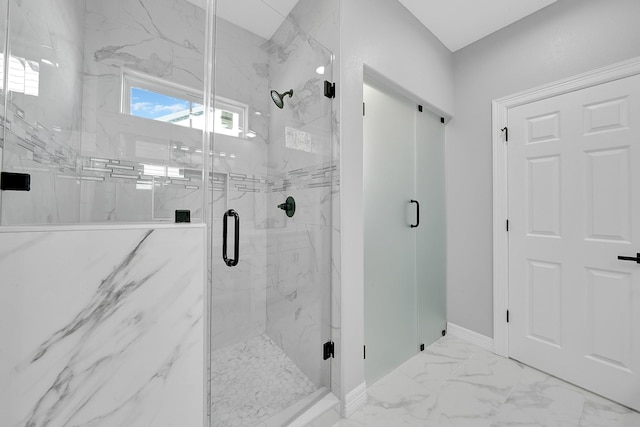 bathroom featuring a shower with door