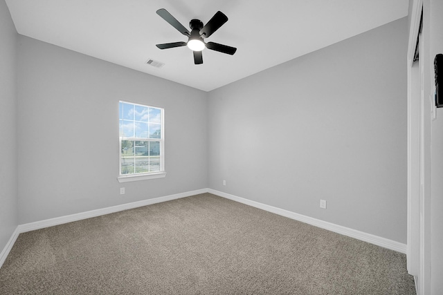 carpeted spare room with ceiling fan