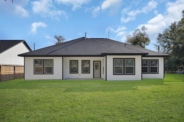 rear view of house with a yard