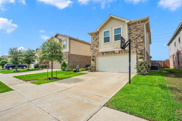 view of front of house with a front yard, a garage, and central AC