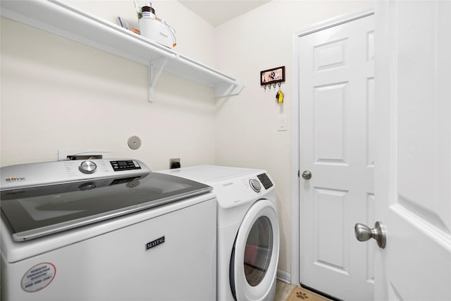 washroom featuring washing machine and dryer