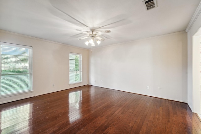 spare room with ceiling fan, dark wood-type flooring, and ornamental molding