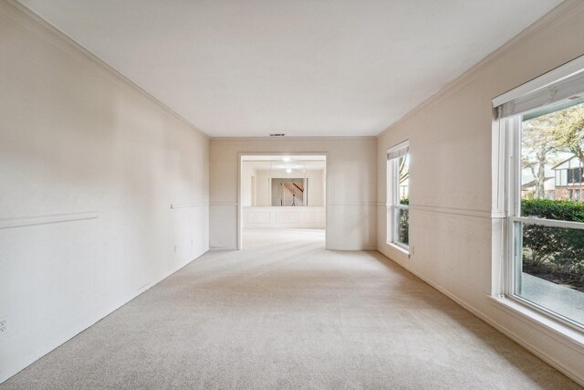 carpeted spare room with crown molding