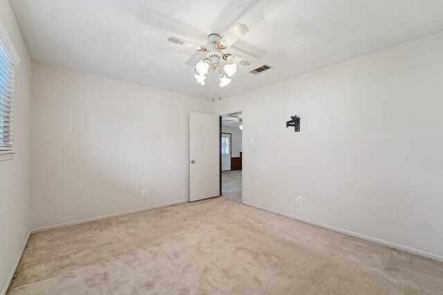 carpeted empty room with ceiling fan