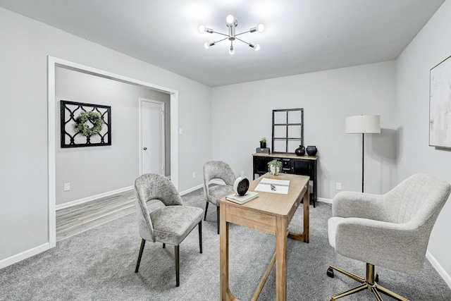 office featuring carpet and an inviting chandelier