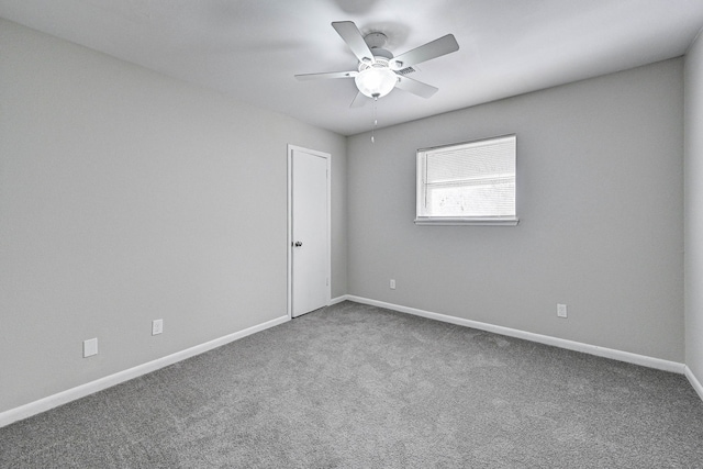 unfurnished room with ceiling fan and carpet floors