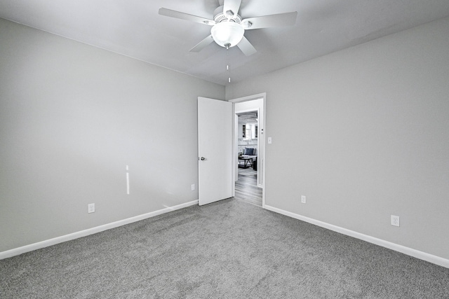 carpeted empty room with ceiling fan