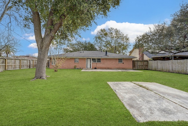 rear view of property with a patio area and a lawn