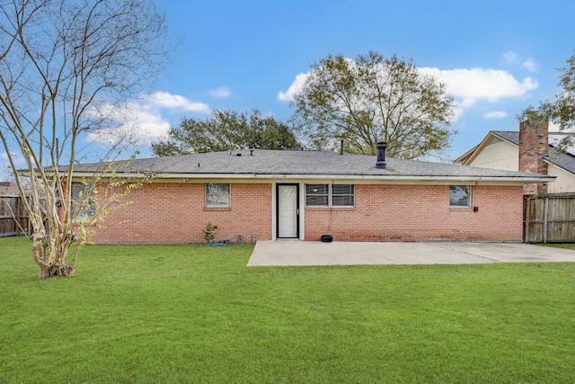 back of house featuring a lawn and a patio