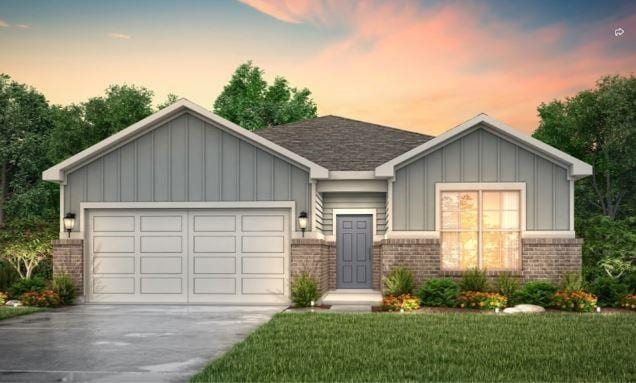 view of front of property with a garage and a lawn