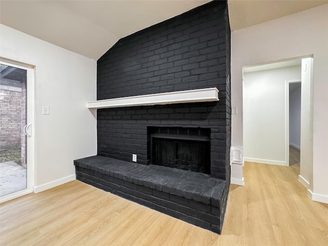 details with a brick fireplace and hardwood / wood-style floors