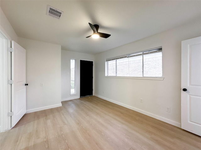 unfurnished bedroom with ceiling fan and light wood-type flooring