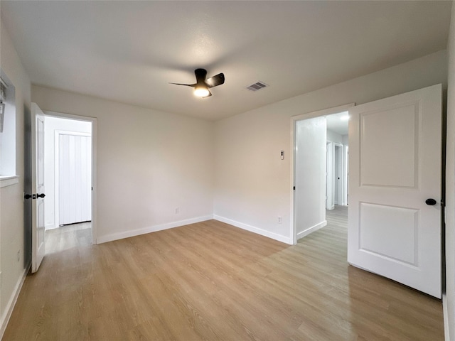 empty room featuring ceiling fan and light hardwood / wood-style floors