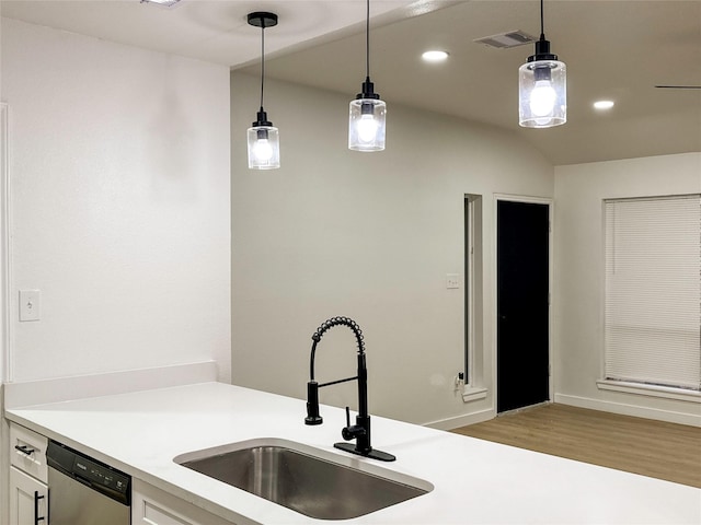 kitchen with white cabinets, dishwasher, sink, and pendant lighting