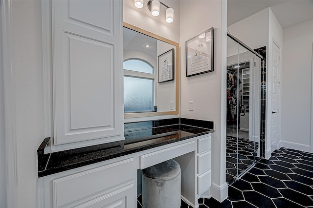 bathroom featuring a shower and vanity