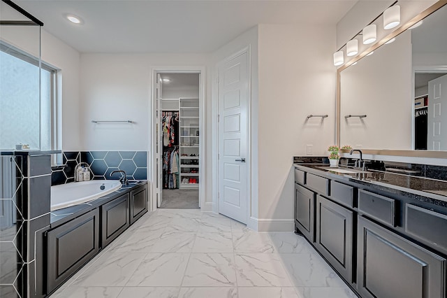 bathroom featuring a washtub and vanity