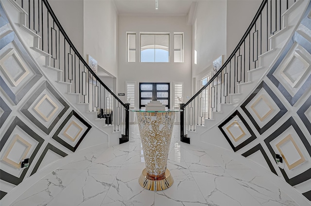 entryway with a towering ceiling