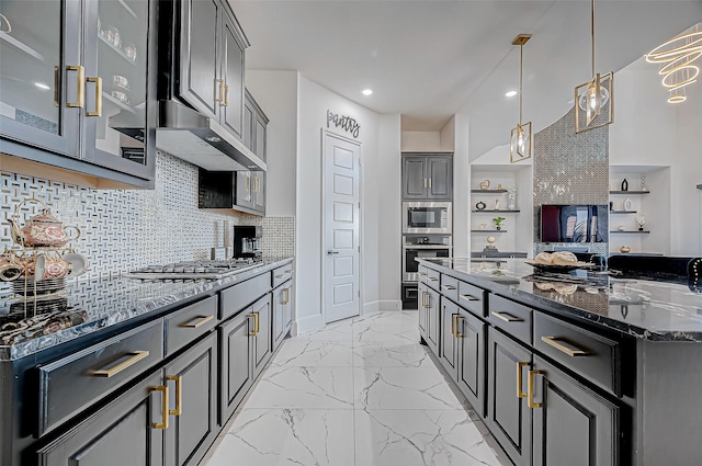 kitchen featuring decorative light fixtures, decorative backsplash, gray cabinetry, stainless steel appliances, and dark stone counters