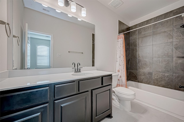 full bathroom featuring toilet, tile patterned flooring, vanity, and shower / tub combo with curtain