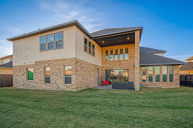 rear view of property featuring an outdoor living space, a patio area, and a yard