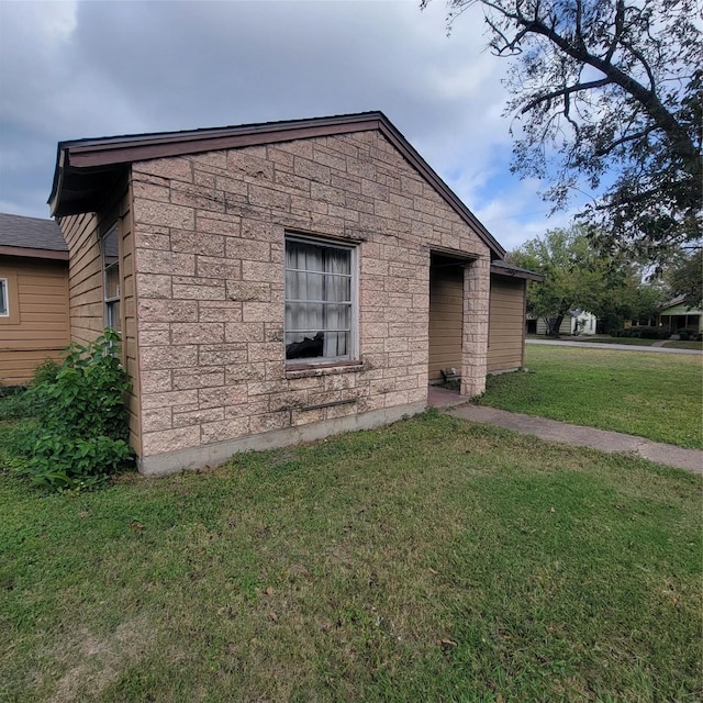 view of side of home featuring a lawn