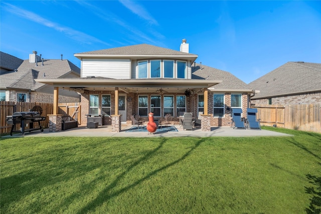 rear view of property with a patio area and a yard