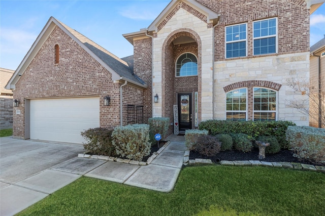 view of front of property featuring a garage and a front lawn