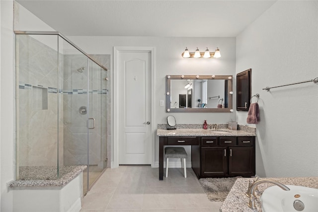 bathroom featuring plus walk in shower, vanity, and tile patterned flooring