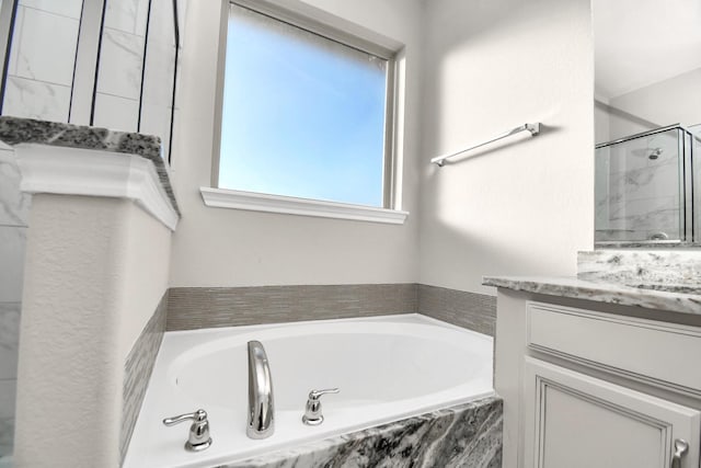 bathroom featuring vanity and plus walk in shower